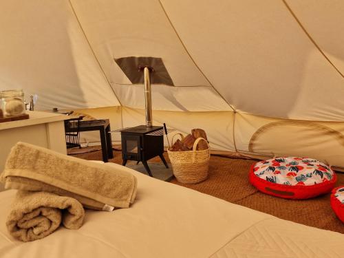 a bedroom with a tent with a towel on a bed at Beautiful 1-Bed bell tent in Holyhead in Holyhead