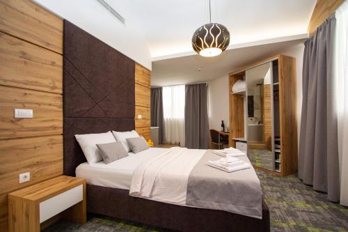a bedroom with a large bed in a room at Hotel Grand in Banja Luka