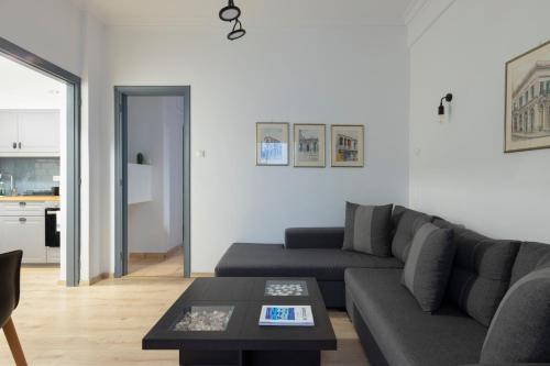 a living room with a couch and a table at Olympic Hadrian view apartment! in Athens