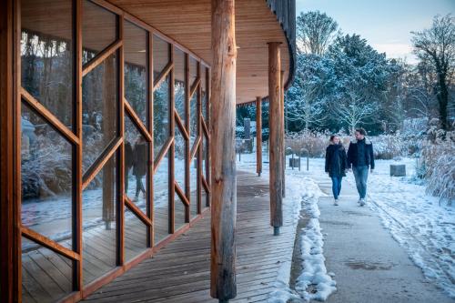 a couple walking down a wooden walkway in the snow at CityKamp Strasbourg in Strasbourg