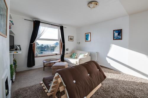 a living room with a couch and a window at Seaview Central in Portsmouth