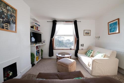 a living room with a couch and a window at Seaview Central in Portsmouth