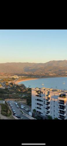 une vue aérienne sur une ville avec un lac et des bâtiments dans l'établissement T1 proche aéroport et plage, à Ajaccio