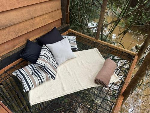 a bench with pillows and a napkin on it at Pousada Santa Thereza in Serra Negra