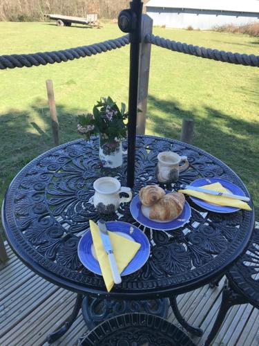 a black table with a plate of food on it at Pooks Rest in Hurst Green