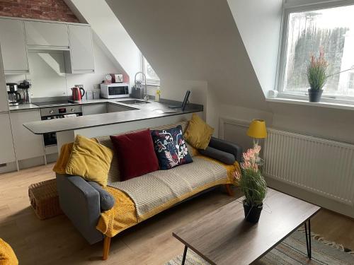 a living room with a couch and a table at Modern Centrally Located Flat in Hastings
