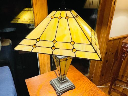 a lamp on a table in a room at Patagonia Home in Shimoda