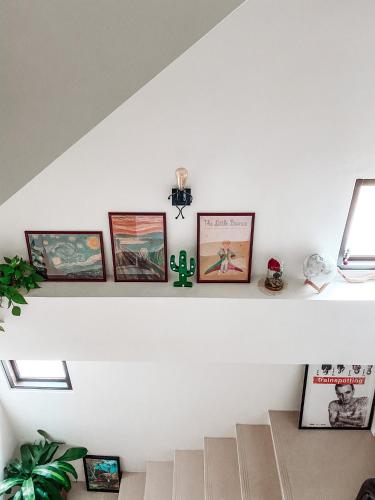 a shelf in a room with pictures on it at 白木宿客WoodWhite House in Toucheng