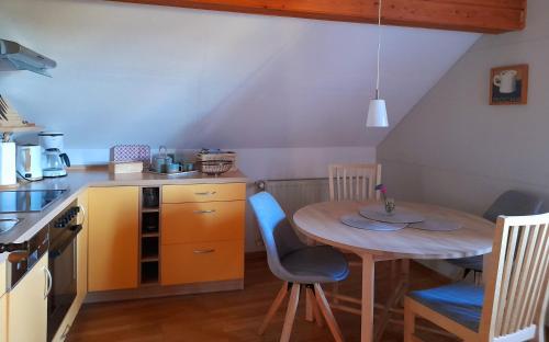 a small kitchen with a table and a table and chairs at Bauernhof Wagner in Eisenach