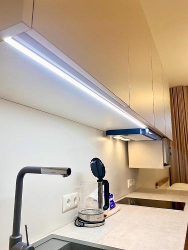 a light above a kitchen counter with a blender at Kastanimaja Apartments in Tartu