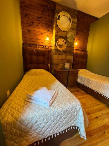 a bedroom with two beds and two mirrors on the wall at Villa Adis with Hot Pool & Jacuzzi by BookVillaBG in Borovets