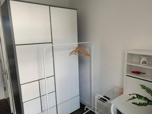 a white refrigerator in a room with a table at Stylish studio flat in City Centre Nottingham in Nottingham