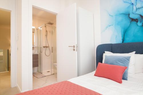 a bedroom with a bed with a red pillow at 200m² NEW Villa F with private, heated pool and amazing ocean view. in Adeje