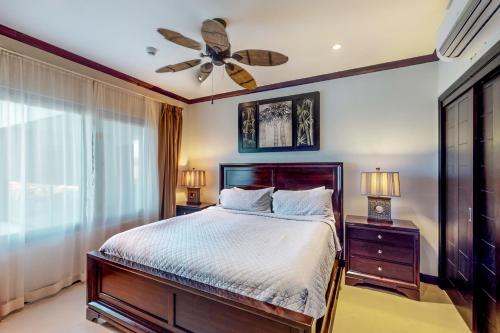 a bedroom with a bed and a ceiling fan at Diamante del Sol 402S in Jacó