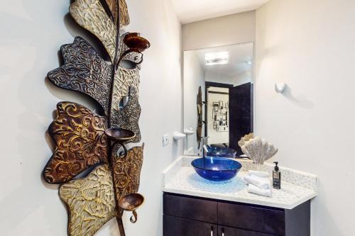 a bathroom with a sink and a mirror at Diamante del Sol 402S in Jacó