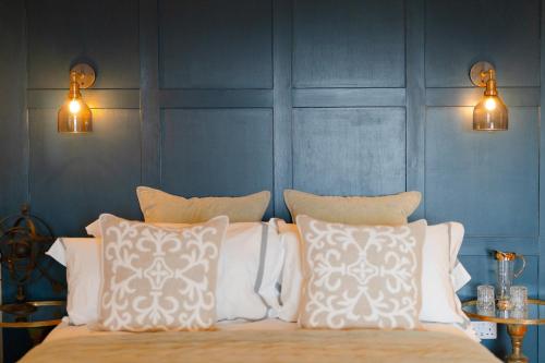 a bedroom with a bed with white pillows at West Highland Hotel in Mallaig