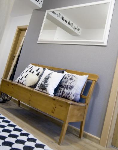 a bedroom with a bed with pillows and a mirror at Haus Filzmoos in Filzmoos