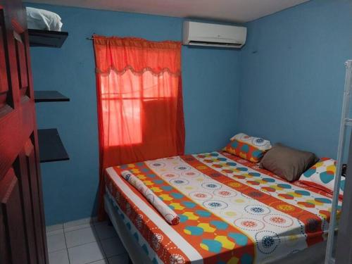 a blue room with a bed in a room at Villa 64 in Quezaltepeque