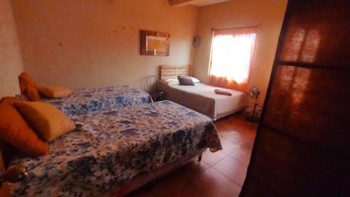 Ένα ή περισσότερα κρεβάτια σε δωμάτιο στο Hosteria del Centro