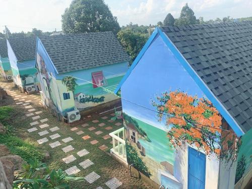 a house with a painting on the side of it at Ngọc Dung Mall Homestay in Tân Phú
