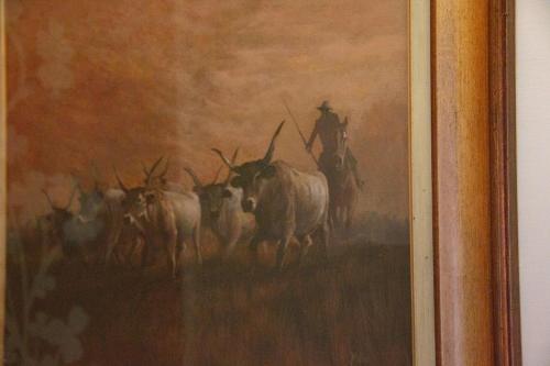 a painting of a rancher and a herd of cattle at Casale la Rovere in Montalto di Castro