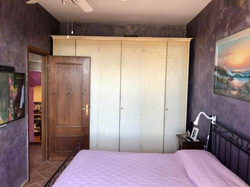 a bedroom with a bed and a wooden closet at Torre degli Alessandri in Viterbo
