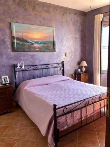 a bedroom with a bed and a painting on the wall at Torre degli Alessandri in Viterbo