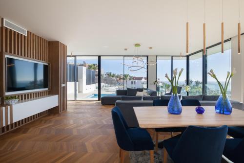 a living room with a table and blue vases at 200m NEW Villa E with priv/heated pool, ocean view. in Adeje