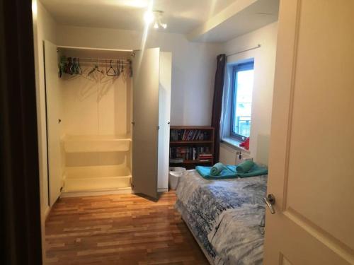 a small bedroom with a bed and a window at 1 Bedroom Flat near Excel, O2, Canary Wharf - London in London