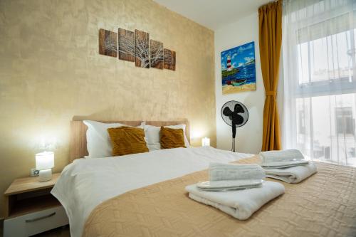 a bedroom with a large bed with towels on it at Modern & Comfortable Apartament Cismigiu Park - POP3 in Bucharest
