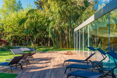 a patio with tables and chairs and trees at Du Lac Et Du Parc Grand Resort in Riva del Garda