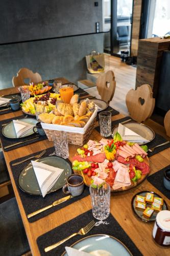 a table with a buffet of food on it at Kellnergut Luxus-Chalet "FRIEDA" in Mühlbach am Hochkönig
