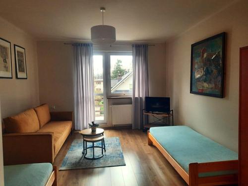 a living room with two beds and a couch at Alfa2 apartament 1 in Bystra