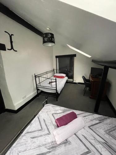 a bedroom with a bed and a desk in a room at The White Hart Inn in Twickenham