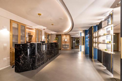 a hallway with black marble counter tops in a building at Du Lac Et Du Parc Grand Resort in Riva del Garda