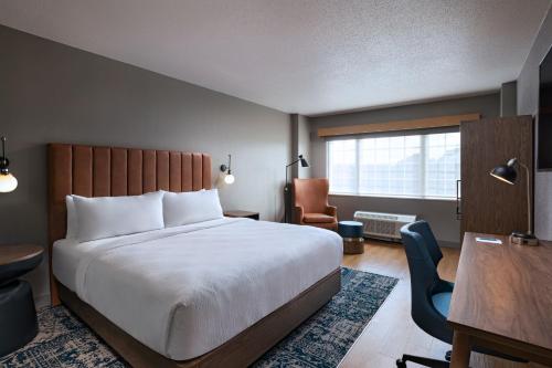 a bedroom with a bed and a desk and a chair at Four Points by Sheraton Houston West in Houston