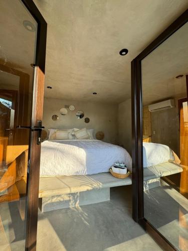 a bedroom with a large bed and a large mirror at Playa Nautilus in Puerto San José