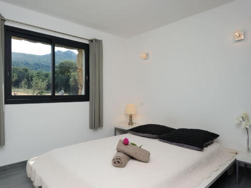 a bedroom with a bed with a stuffed animal on it at Clos Simoni in Figari