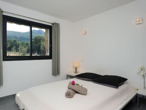 a bedroom with a bed with a stuffed animal on it at Clos Simoni in Figari