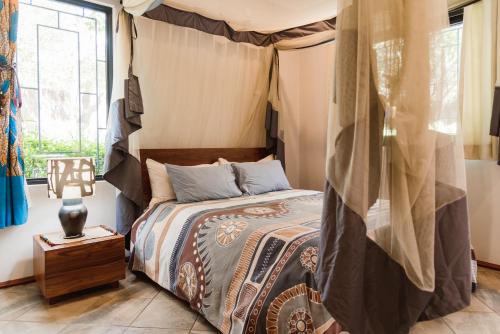 a bedroom with a bed and a window at Mama Tembo Cheza 01 in Lusaka