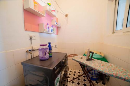 a small bathroom with a stove and a sink at Airport Vista Getaway-4km from jomo Kenyatta International Airport in Nairobi