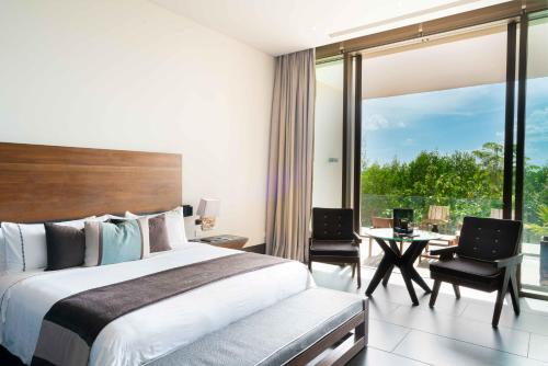 a hotel room with a bed and a large window at NIZUC Resort & Spa in Cancún