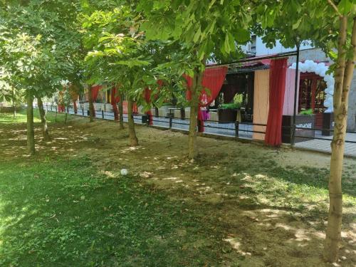 a row of trees in front of a building at City Center Apartment 1 in Tashkent