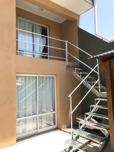 a metal staircase on the side of a building at Verona Hostel in Necochea