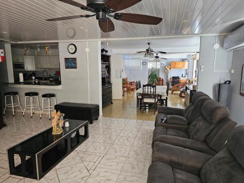 a living room with a couch and a table at oasis with pool near Panama Canal in Panama City