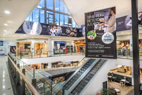 a shopping mall with a sign in the middle at Leichhardt Serene Retreat - Views丨Parking丨Ease in Sydney