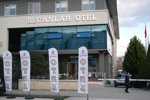 a man walking in front of a building at BECANLAR OTEL in Yalova
