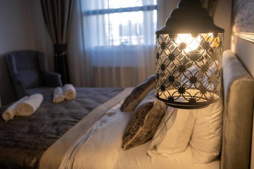 a bedroom with a bed with a lamp on it at BECANLAR OTEL in Yalova
