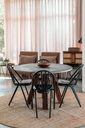 a table and chairs in a living room at Lamego Hotel & Life in Lamego