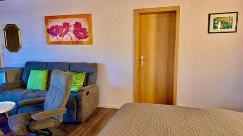 a living room with a couch and a chair at KrabatResidenz - Apartmenthaus in Burg